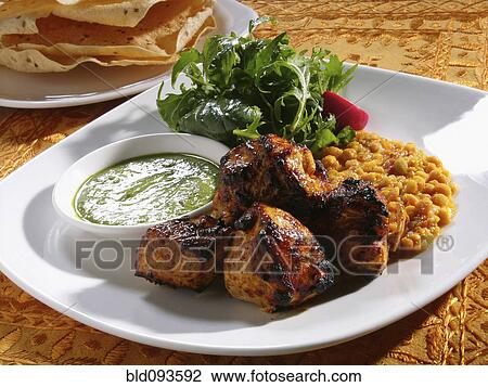 Stock Image - Close up of chicken tandoori entree. Fotosearch