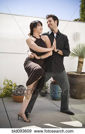Couple dancing together on patio View Large Photo Image Stock Photo - Couple dancing together on patio. Fotosearch