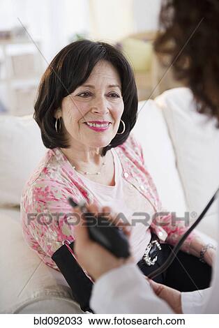 Doctor taking patient's blood pressure View Large Photo Image Stock Image - Doctor taking patient's blood pressure. Fotosearch