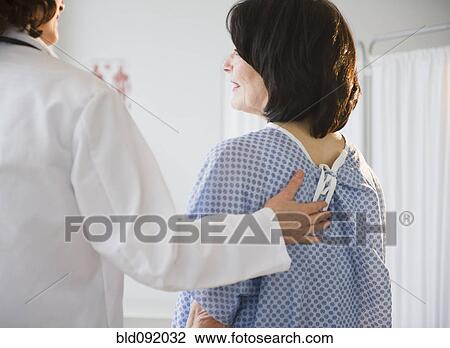 Doctor with patient in examination room View Large Photo Image Stock Image - Doctor with patient in examination room. Fotosearch