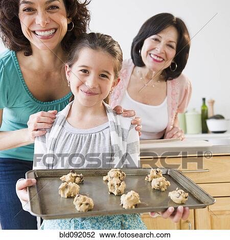Stock Image - Family baking cookies together. Fotosearch