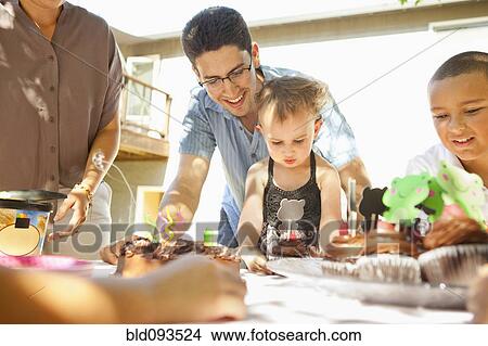 Family enjoying meal outdoors View Large Photo Image Picture - Family enjoying meal outdoors. Fotosearch