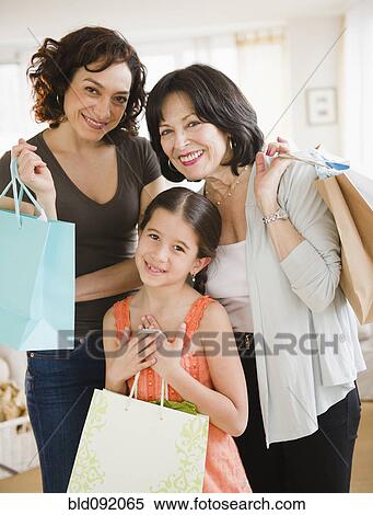 Stock Photography - Family holding shopping bags. Fotosearch