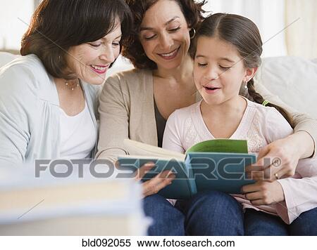 Stock Photography - Family reading book together. Fotosearch