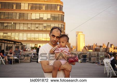 Father holding baby daughter on urban deck View Large Photo Image Stock Image - Father holding baby daughter on urban deck. Fotosearch