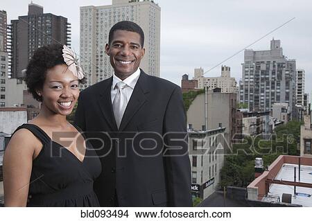 Glamorous African American couple standing on rooftop View Large Photo Image Picture - Glamorous African American couple standing on rooftop. Fotosearch