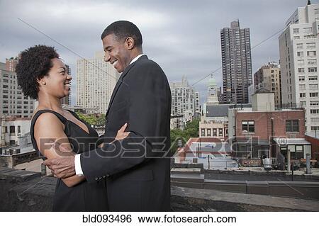 Glamorous African American couple standing on rooftop View Large Photo Image Stock Photograph - Glamorous African American couple standing on rooftop. Fotosearch