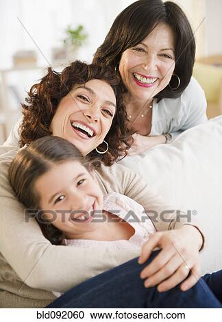 Stock Image - Granddaughter, mother and daughter hugging. Fotosearch