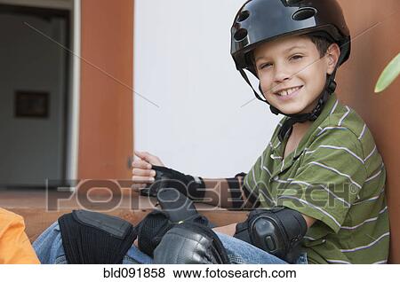 Hispanic boy in skateboard pads and helmet View Large Photo Image Stock Photo - Hispanic boy in skateboard pads and helmet. Fotosearch
