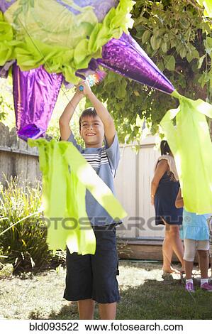 Hispanic boy trying to hit pinata View Large Photo Image Stock Image - Hispanic boy trying to hit pinata. Fotosearch