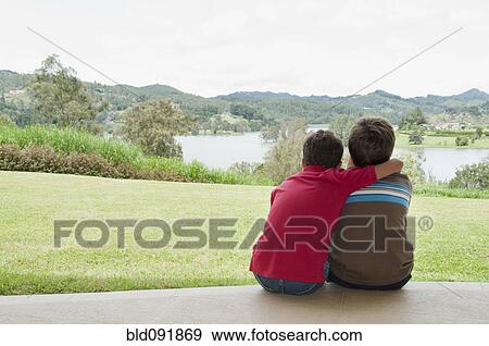 Hispanic boys hugging and looking at view View Large Photo Image Stock Photo - Hispanic boys hugging and looking at view. Fotosearch