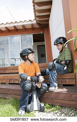 Hispanic boys in pads and helmets holding skateboards View Large Photo Image Stock Photo - Hispanic boys in pads and helmets holding skateboards. Fotosearch