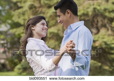 Hispanic couple dancing together outdoors View Large Photo Image Stock Image - Hispanic couple dancing together outdoors. Fotosearch