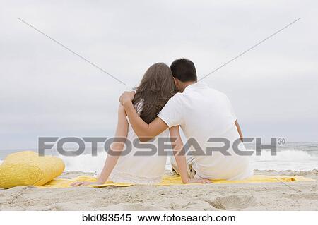 Hispanic couple sitting on beach together View Large Photo Image Stock Photography - Hispanic couple sitting on beach together. Fotosearch