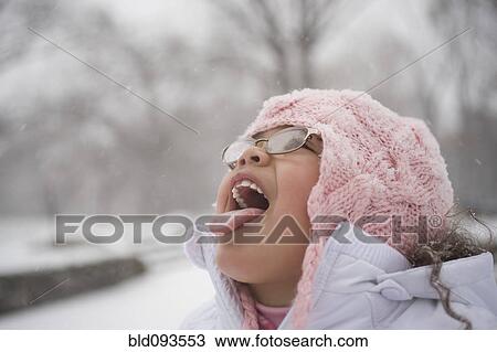 Hispanic girl catching snowflakes on tongue View Large Photo Image Stock Image - Hispanic girl catching snowflakes on tongue. Fotosearch