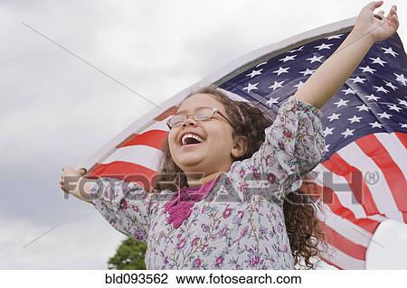 Hispanic girl holding American flag with arms raised View Large Photo Image Stock Image - Hispanic girl holding American flag with arms raised. Fotosearch