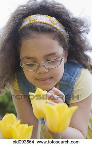 Hispanic girl smelling flower View Large Photo Image Picture - Hispanic girl smelling flower. Fotosearch