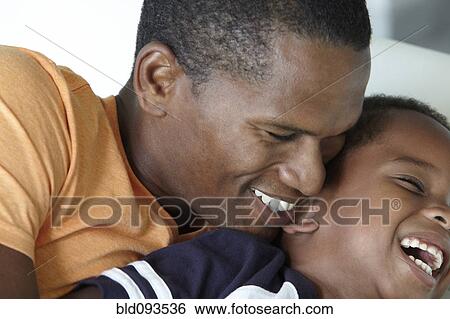 Laughing African American father and son View Large Photo Image Stock Photograph - Laughing African American father and son. Fotosearch
