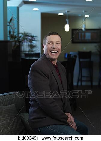 Stock Image - Laughing Caucasian businessman. Fotosearch