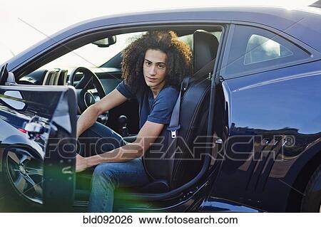 Mixed race teenager sitting in car View Large Photo Image Stock Photograph - Mixed race teenager sitting in car. Fotosearch