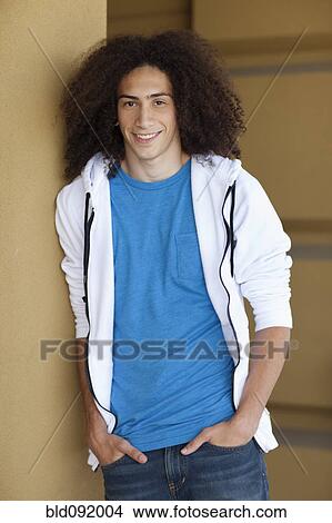 Mixed race teenager standing with hands in pockets View Large Photo Image Picture - Mixed race teenager standing with hands in pockets. Fotosearch