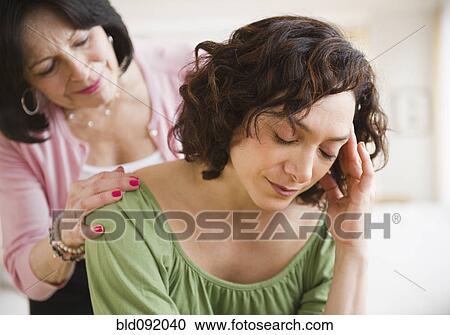 Stock Image - Mother comforting daughter. Fotosearch