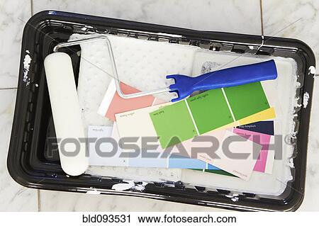Stock Image - Paint roller, tray and color swatches. Fotosearch