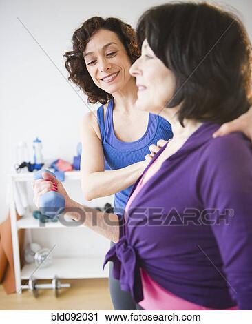Personal trainer working with women in health club View Large Photo Image Stock Image - Personal trainer working with women in health club. Fotosearch