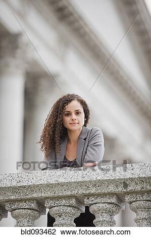 Serious Caucasian businesswoman leaning on railing View Large Photo Image Stock Image - Serious Caucasian businesswoman leaning on railing. Fotosearch
