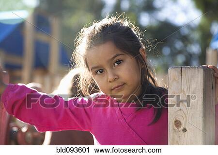 Serious Hispanic girl playing on playground View Large Photo Image Stock Image - Serious Hispanic girl playing on playground. Fotosearch