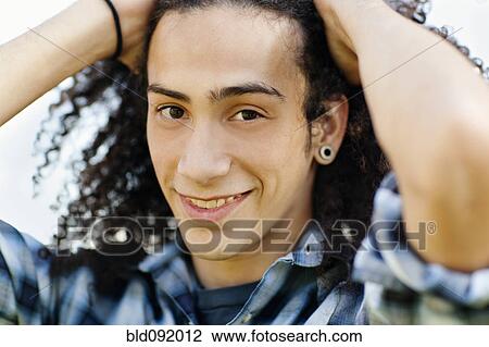 Smiling mixed race teenager with head in hands View Large Photo Image Stock Image - Smiling mixed race teenager with head in hands. Fotosearch