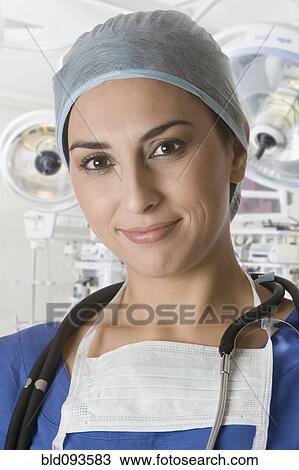 Stock Image - Smiling Turkish doctor in operating room. Fotosearch