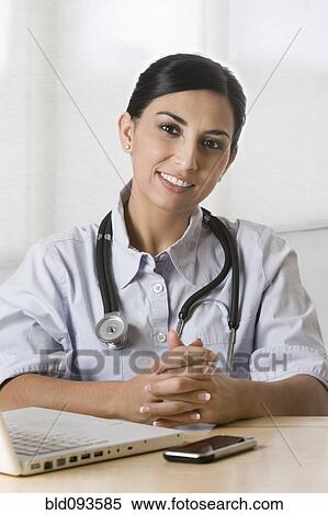 Turkish doctor sitting in doctor's office View Large Photo Image Stock Photography - Turkish doctor sitting in doctor's office. Fotosearch
