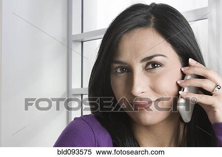 Stock Photography - Turkish woman talking on cell phone. Fotosearch