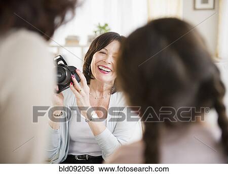 Woman taking picture of daughter and granddaughter View Large Photo Image Stock Photo - Woman taking picture of daughter and granddaughter. Fotosearch