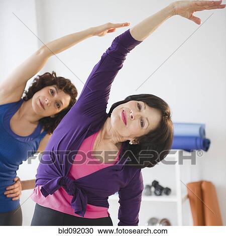 Stock Image - Women exercising in health club. Fotosearch