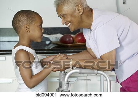 Stock Image - African American grandmother holding hands with grandson. Fotosearch