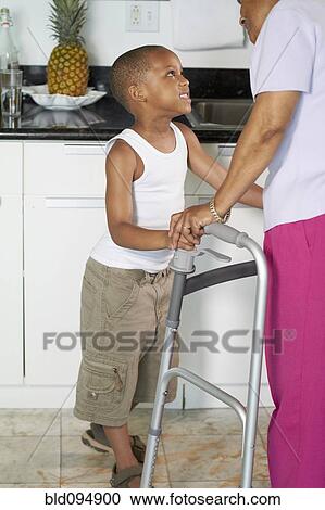 Stock Image - African American grandson talking to grandmother. Fotosearch