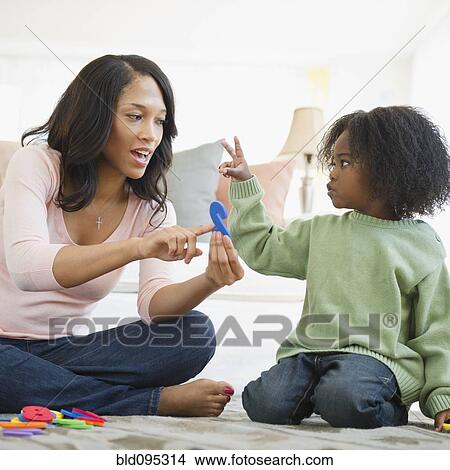 Picture - African American mother teaching son numbers. Fotosearch