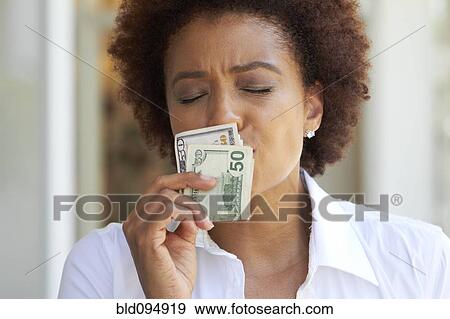 Stock Photo - African American woman kissing 50 dollar bill. Fotosearch