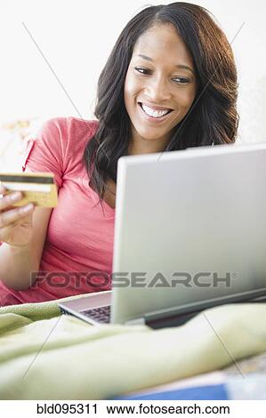 African American woman shopping online with credit card View Large Photo Image Stock Image - African American woman shopping online with credit card. Fotosearch