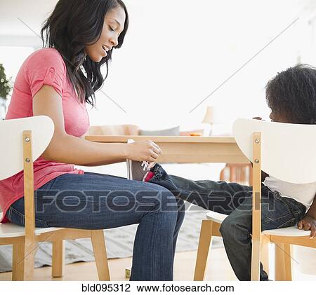 African American woman tying son's shoes View Large Photo Image Stock Image - African American woman tying son's shoes. Fotosearch