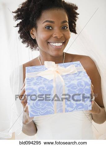 Black bride holding wedding gift View Large Photo Image Stock Photography - Black bride holding wedding gift. Fotosearch