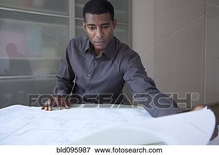 Black businessman reviewing blueprints View Large Photo Image Stock Photo - Black businessman reviewing blueprints. Fotosearch