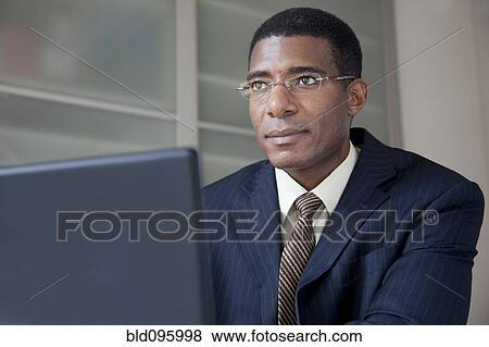 Black businessman using laptop View Large Photo Image Stock Photo - Black businessman using laptop. Fotosearch