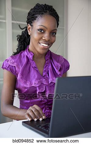 Black businesswoman typing on laptop View Large Photo Image Stock Image - Black businesswoman typing on laptop. Fotosearch