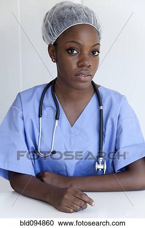Stock Image - Black doctor in scrubs and surgical cap. Fotosearch