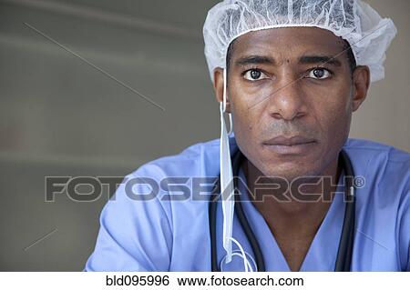 Stock Photograph - Black doctor in scrubs and surgical cap. Fotosearch