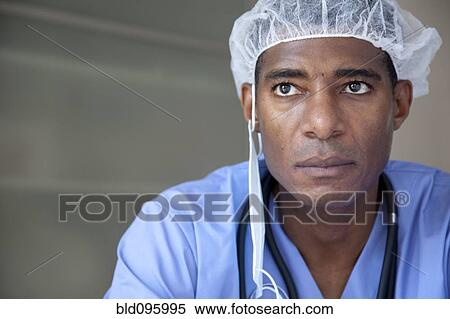 Stock Photography - Black doctor in scrubs and surgical cap. Fotosearch