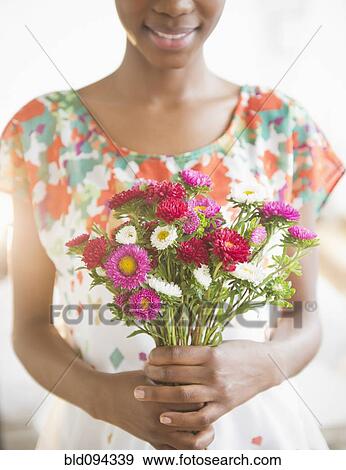 Black woman holding bouquet of flowers View Large Photo Image Stock Photo - Black woman holding bouquet of flowers. Fotosearch